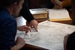 Visitors study a historic map in the Sacramento Room